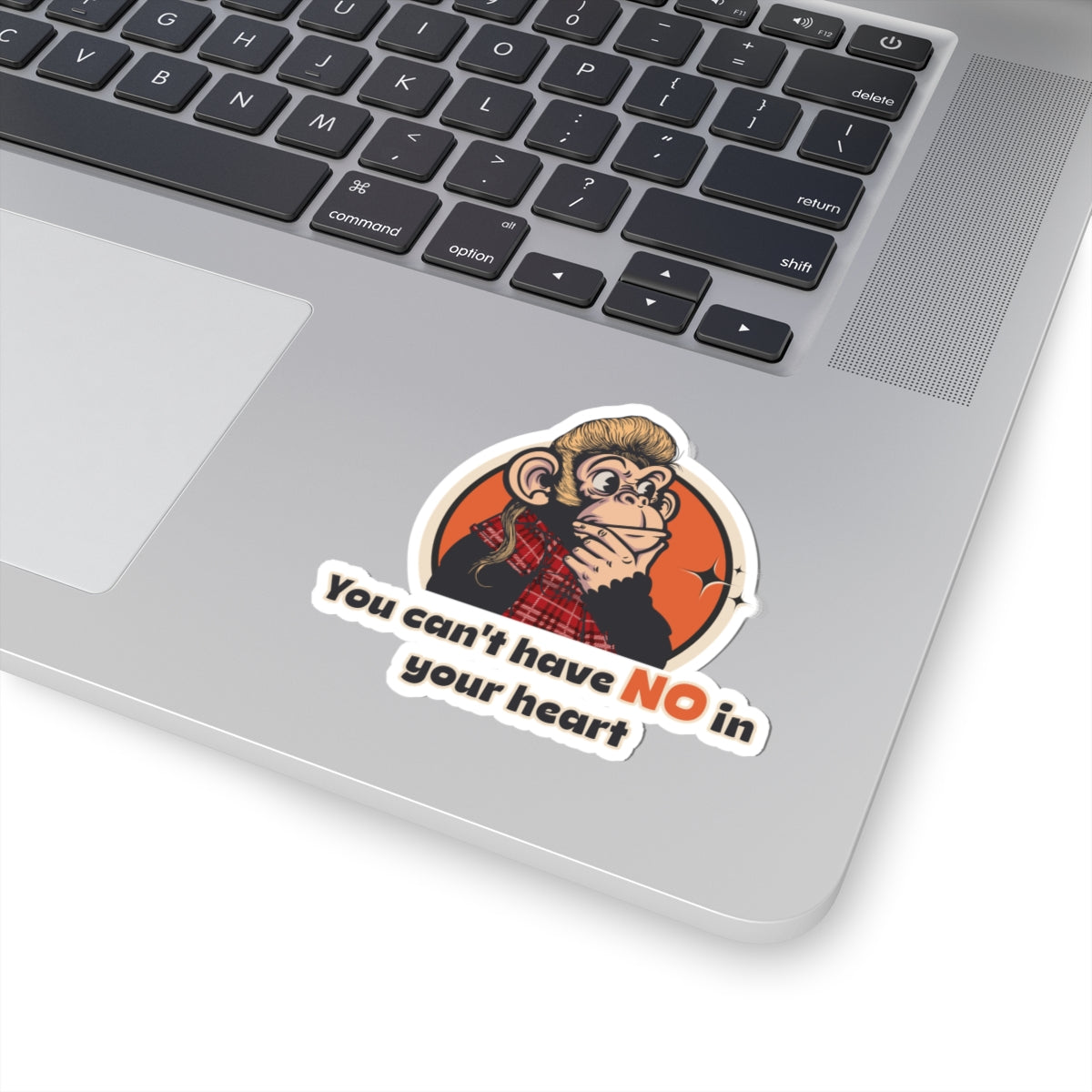 Laptop with a “You Can’t Have No in Your Heart” Throwback Jack Sticker Inspired by Joe Dirt on the palm rest area.